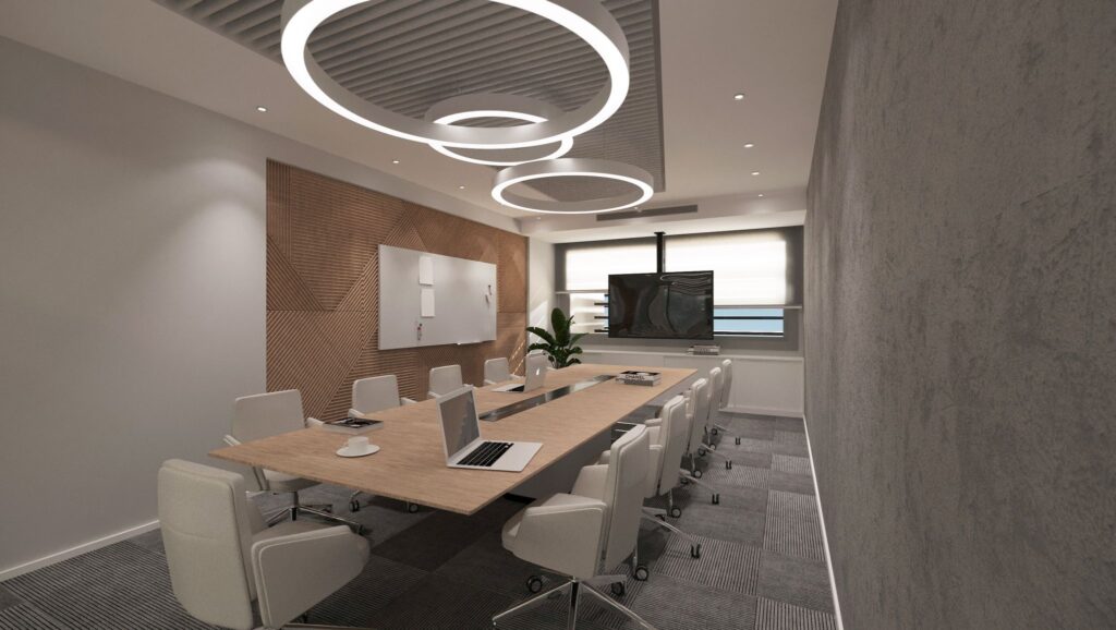 Modern aydınlatma ve minimalist mobilyalarla tasarlanmış, verimli toplantılar için ideal bir ofis toplantı odası.