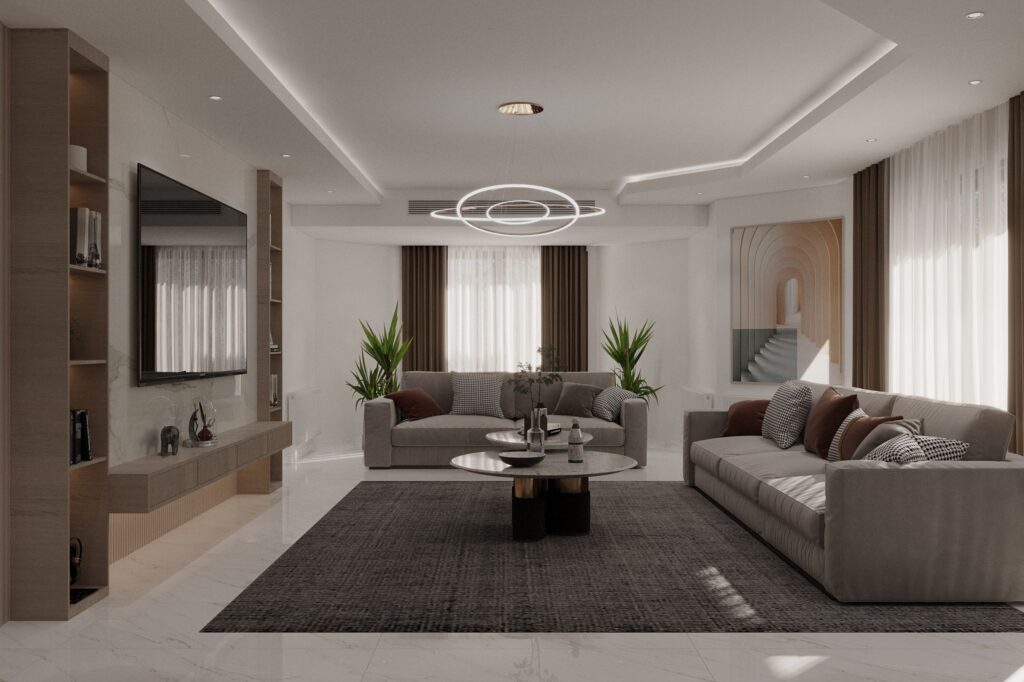 Açık plan yaşam alanına sahip, gri kanepeler ve modern TV ünitesiyle tasarlanmış salon.