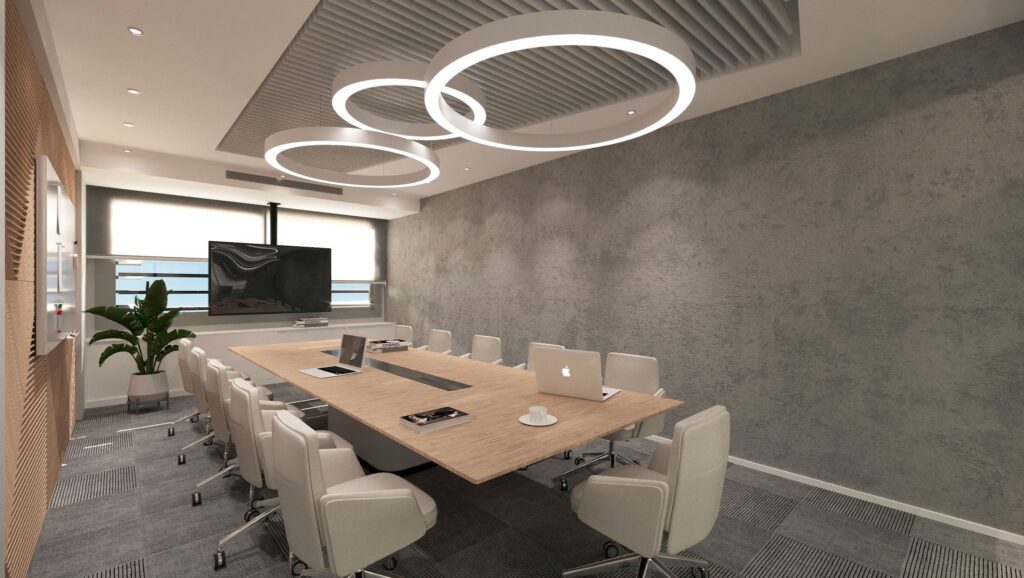 Modern Kurumsal Ofis Tasarımı Yuvarlak LED aydınlatmalar ve ahşap detaylarla tasarlanmış, profesyonel bir toplantı salonu.