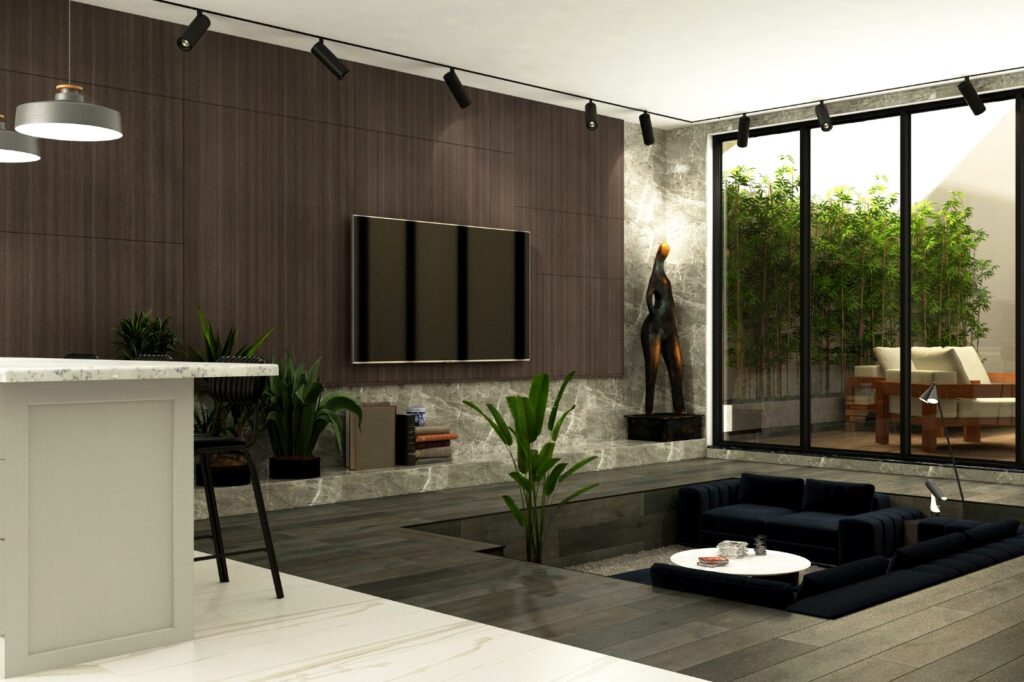 Aile Dostu Modern Villa Tasarımı Batık oturma alanı ve büyük cam cephesiyle dışarıyla bütünleşen modern salon.