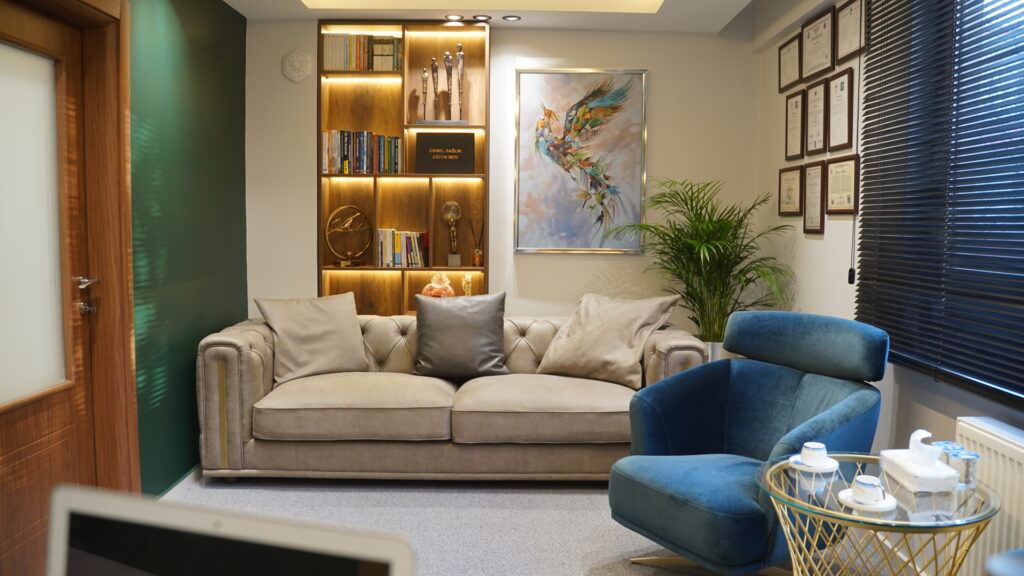 Psikolojik Danışmanlık Ofis Tasarımı Sanat eseri ve konforlu kanepelerle tasarlanmış, sıcak bir atmosfer sunan ofis bekleme odası.